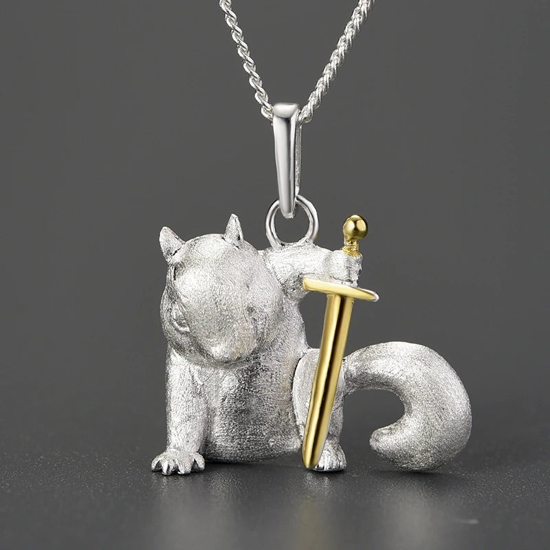 Silver squirrel pendant with a gold sword on a grey  background